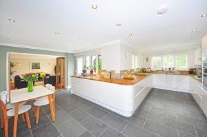 Brown and white wooden kitchen island and gray floor tiling