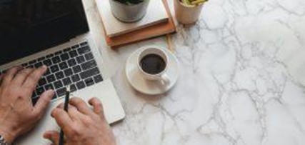 Laptop and coffee on table